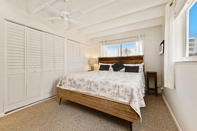 carpeted bedroom featuring beam ceiling and ceiling fan