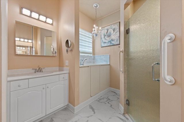 bathroom with vanity, an inviting chandelier, and an enclosed shower