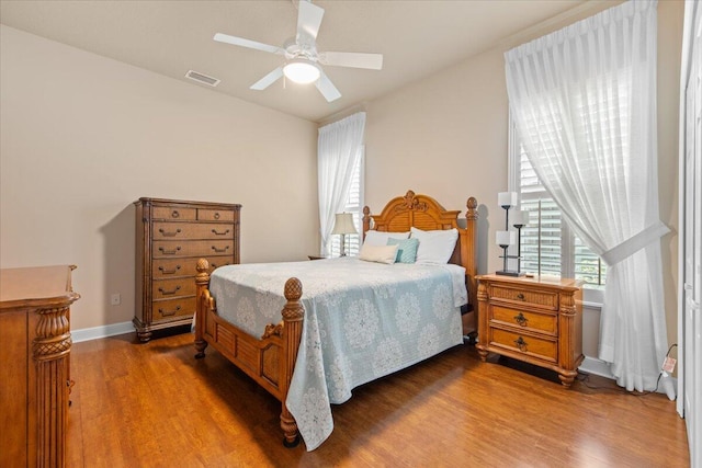 bedroom with ceiling fan and dark wood-type flooring