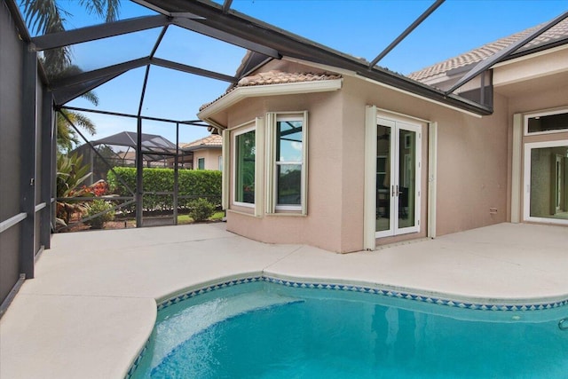 view of pool featuring a patio and glass enclosure