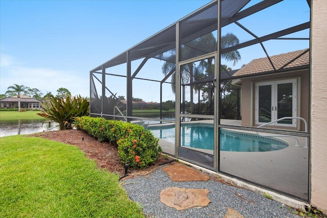 view of pool featuring a lanai, a patio, a water view, and french doors