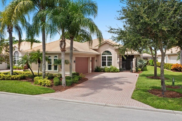 view of front of house with a garage and a front lawn