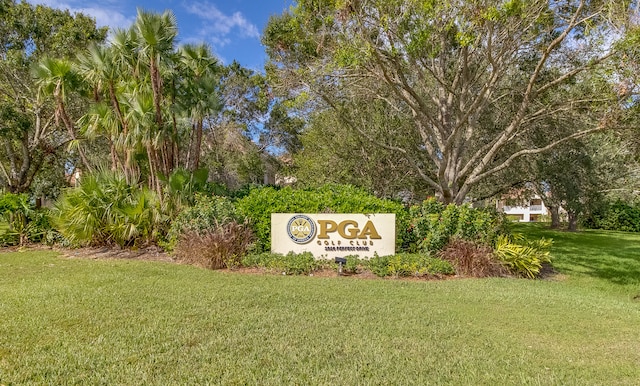 community sign featuring a lawn