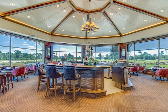 bar featuring a notable chandelier, wood ceiling, light colored carpet, and high vaulted ceiling