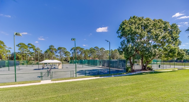 view of sport court featuring a yard