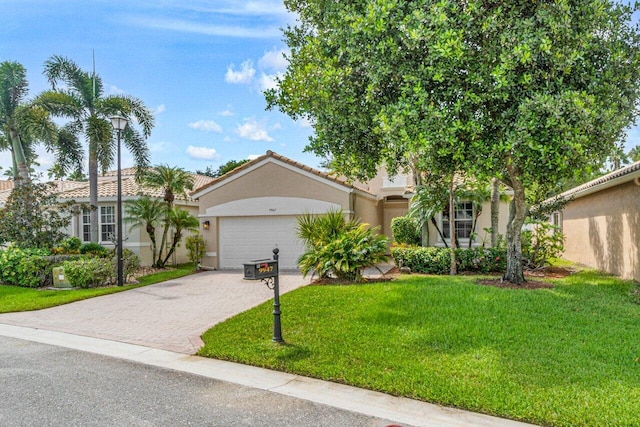 view of front of house featuring a front yard and a garage