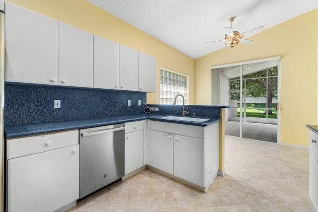 kitchen featuring ceiling fan, dishwasher, vaulted ceiling, and white cabinetry