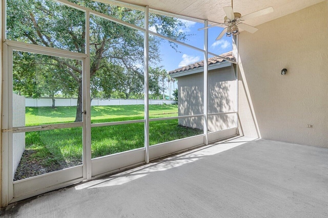 unfurnished sunroom with ceiling fan and a wealth of natural light