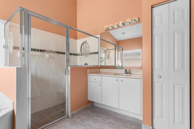 bathroom featuring shower with separate bathtub, tile patterned floors, and vanity