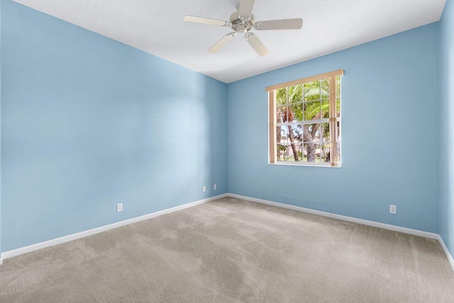 carpeted empty room featuring a textured ceiling and ceiling fan