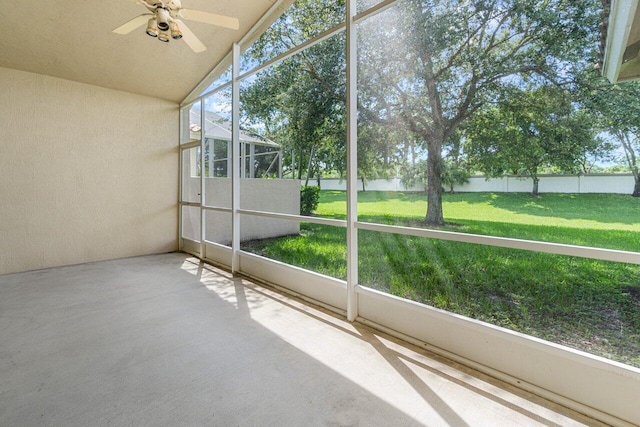 unfurnished sunroom featuring ceiling fan and lofted ceiling