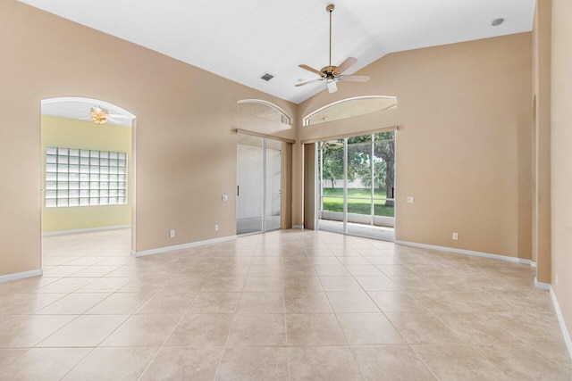 tiled empty room featuring high vaulted ceiling and ceiling fan