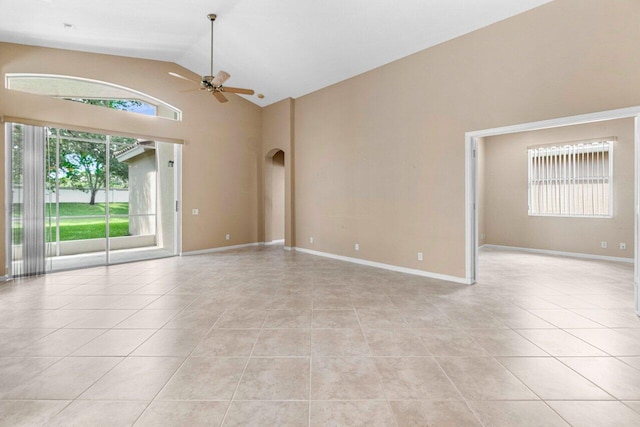 unfurnished room with high vaulted ceiling, ceiling fan, and light tile patterned floors