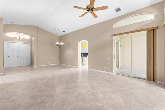 spare room featuring ceiling fan with notable chandelier, lofted ceiling, and light tile patterned flooring