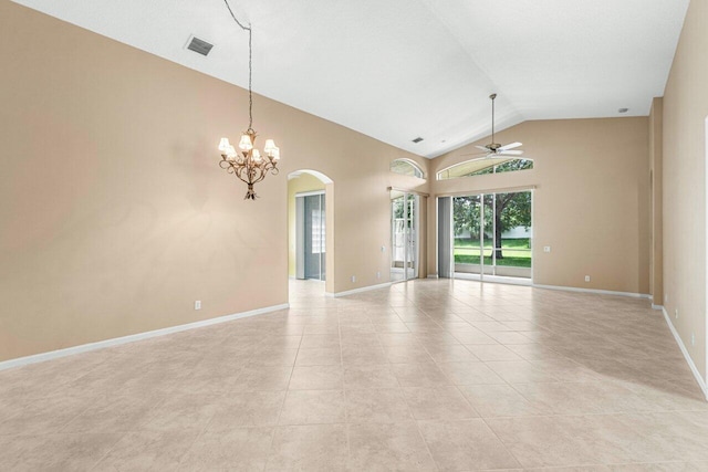 tiled spare room featuring ceiling fan with notable chandelier and vaulted ceiling