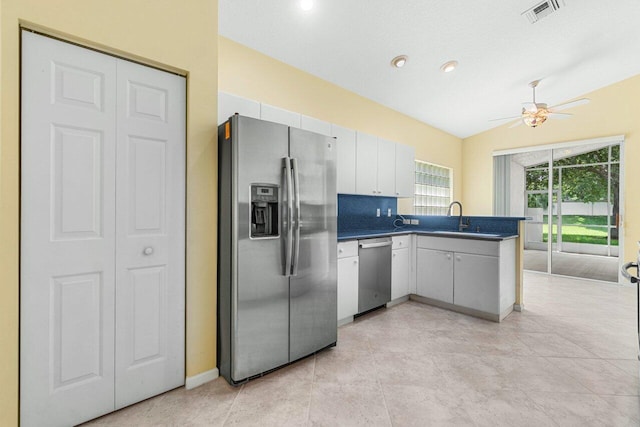 kitchen featuring sink, white cabinetry, vaulted ceiling, stainless steel appliances, and ceiling fan