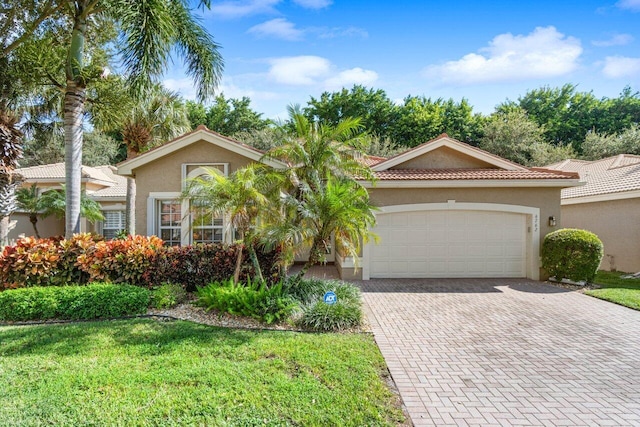 view of front of property with a front lawn and a garage