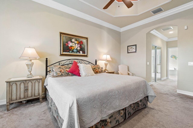 carpeted bedroom with ornamental molding and ceiling fan