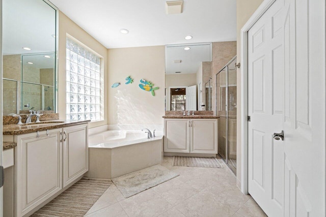 bathroom featuring tile patterned floors, vanity, and separate shower and tub