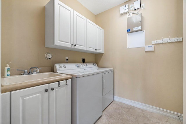 washroom featuring cabinets, a textured ceiling, light tile patterned flooring, sink, and separate washer and dryer