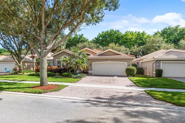 view of front of property with a garage and a front lawn