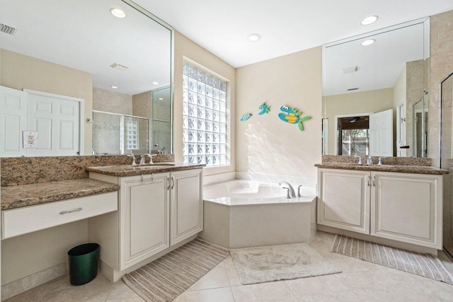 bathroom with tile patterned floors, independent shower and bath, and vanity