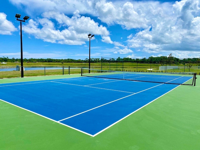 view of sport court with a water view