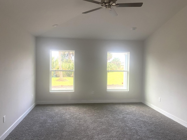 carpeted empty room featuring plenty of natural light and ceiling fan