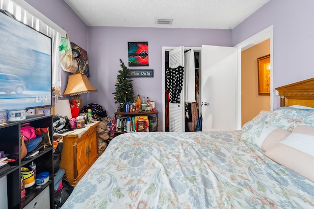 bedroom with a closet and a textured ceiling