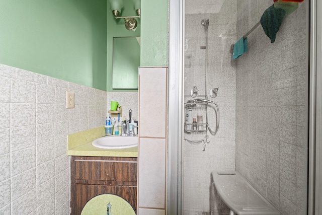 bathroom featuring tile walls, vanity, toilet, and an enclosed shower