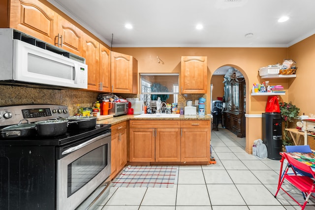 kitchen featuring sink, crown molding, light tile patterned flooring, and stainless steel electric range oven