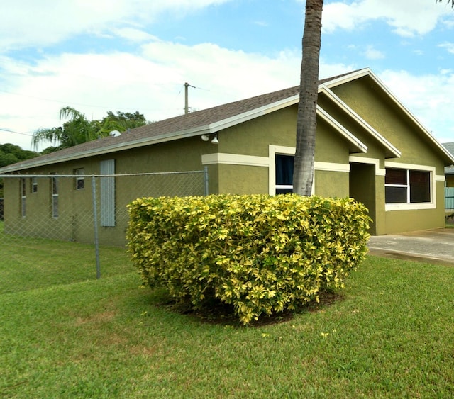 view of side of property with a lawn