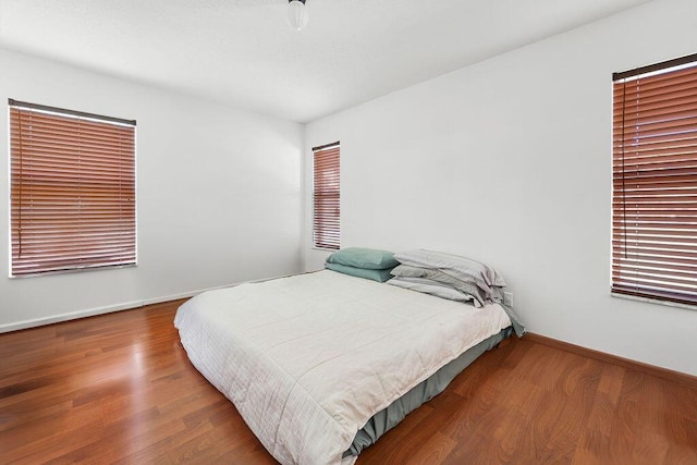 bedroom with hardwood / wood-style flooring