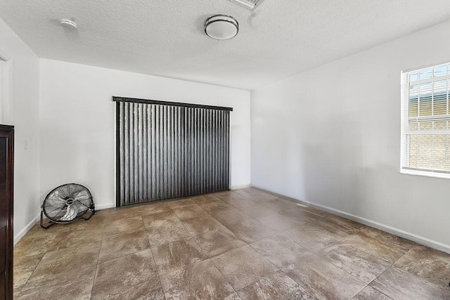 spare room with a textured ceiling