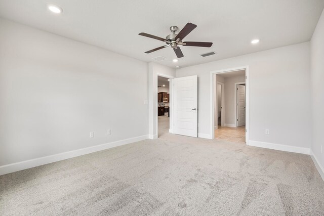 unfurnished bedroom with light colored carpet and ceiling fan