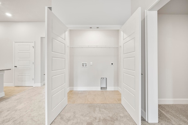 clothes washing area featuring washer hookup, light colored carpet, and electric dryer hookup