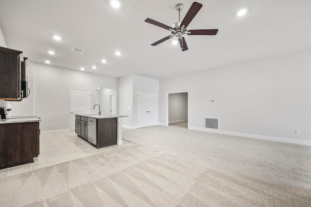 interior space with ceiling fan, light colored carpet, and sink