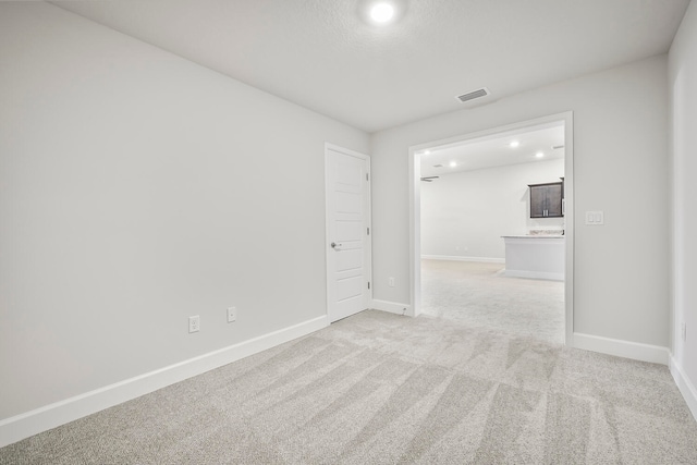 unfurnished room with light colored carpet