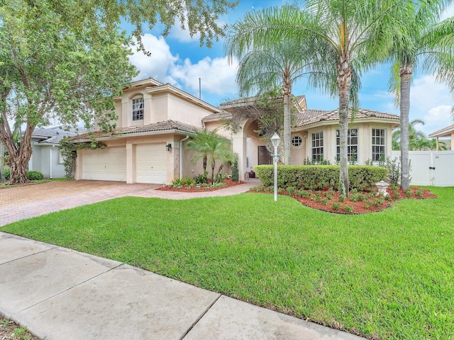 mediterranean / spanish home with a garage and a front yard