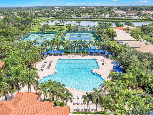 view of swimming pool featuring a water view and a patio area