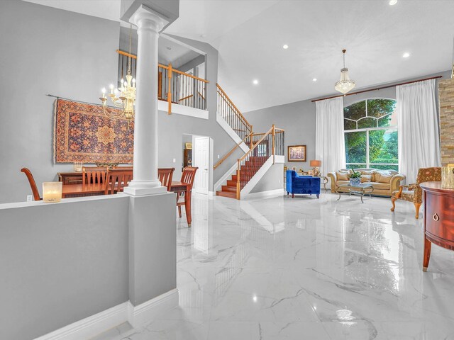 foyer with a notable chandelier and decorative columns