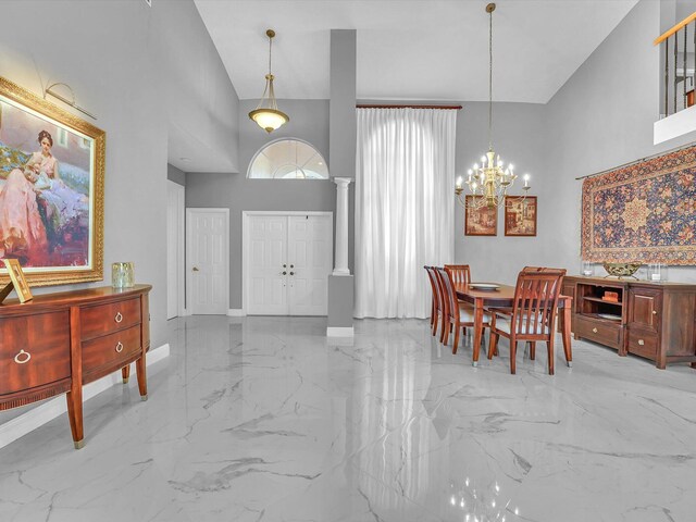 dining room featuring high vaulted ceiling, decorative columns, and an inviting chandelier