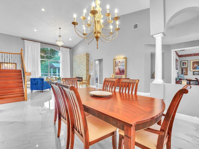 dining space featuring vaulted ceiling, decorative columns, and an inviting chandelier