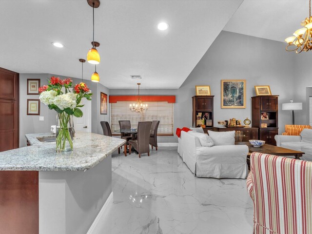 living room featuring an inviting chandelier and vaulted ceiling