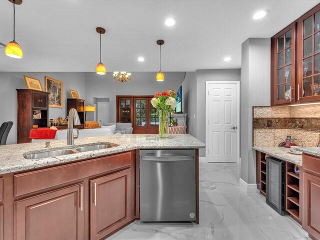 kitchen with sink, light stone counters, tasteful backsplash, decorative light fixtures, and dishwasher