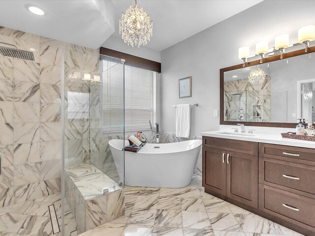 bathroom with vanity, shower with separate bathtub, and a notable chandelier