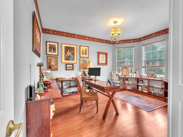 office space featuring hardwood / wood-style floors, a chandelier, and a textured ceiling