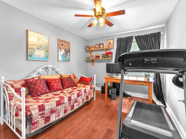 bedroom with hardwood / wood-style flooring, a textured ceiling, and ceiling fan