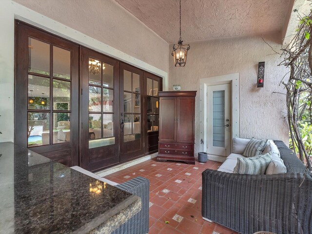 view of exterior entry with french doors and a patio area