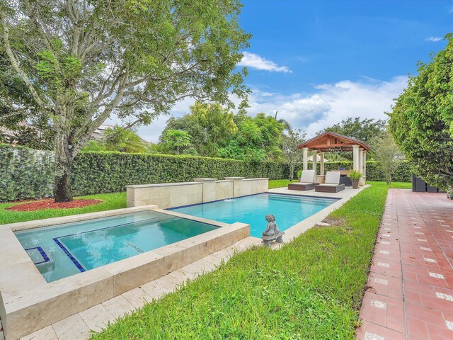 view of swimming pool featuring a patio area, a gazebo, and an in ground hot tub